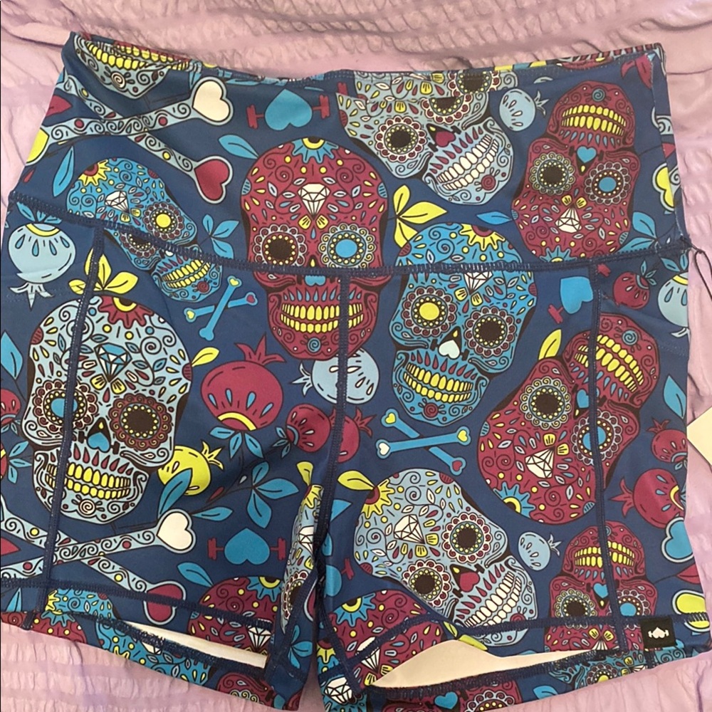 Vibrant Blue and Red Bike Shorts with Ornate Skull Design